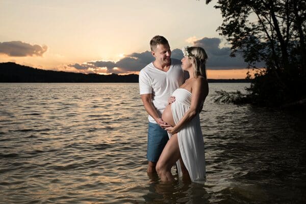 A man and woman standing in the water.