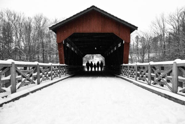 A group of people standing on the side of a bridge.